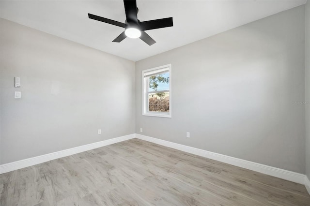 spare room with light wood-style flooring, baseboards, and a ceiling fan