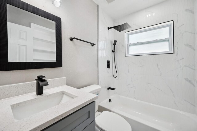 bathroom with toilet, bathing tub / shower combination, and vanity