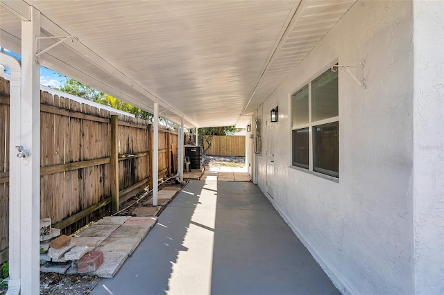 view of patio / terrace with cooling unit and fence