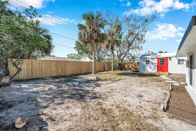 view of yard with an outbuilding and a fenced backyard