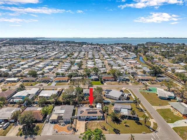 drone / aerial view with a water view and a residential view