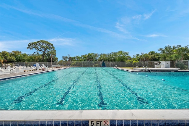 community pool featuring a patio area and fence