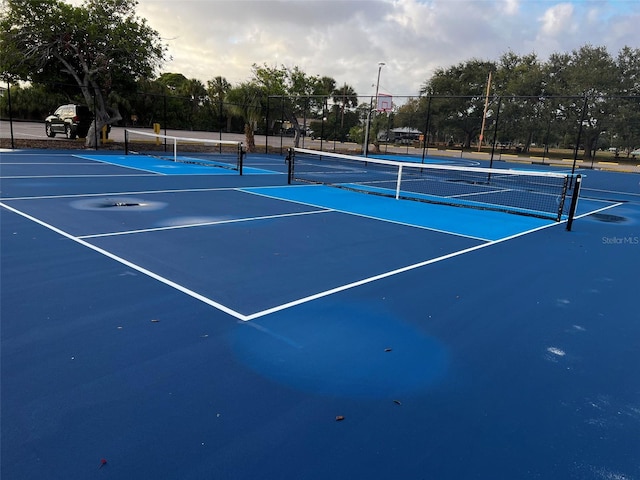 view of sport court featuring fence