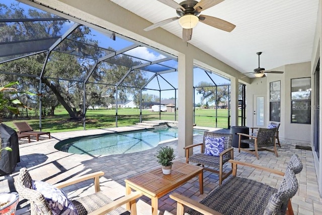 view of pool featuring ceiling fan, a lanai, a patio area, and a lawn