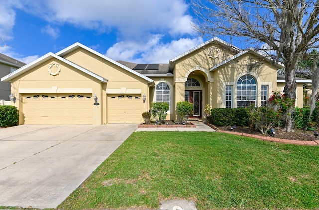 view of front facade with a garage, solar panels, and a front lawn