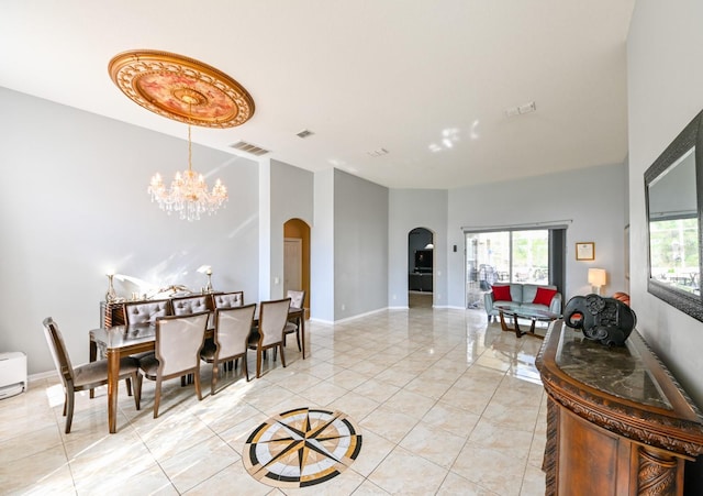 tiled dining space featuring a chandelier