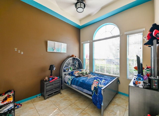 tiled bedroom with ceiling fan