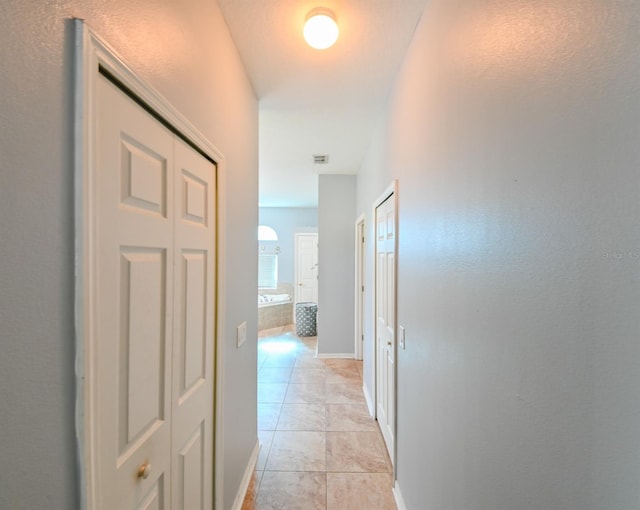 corridor featuring light tile patterned floors