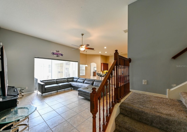 tiled living room with ceiling fan