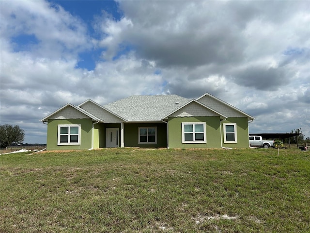 back of house featuring a lawn