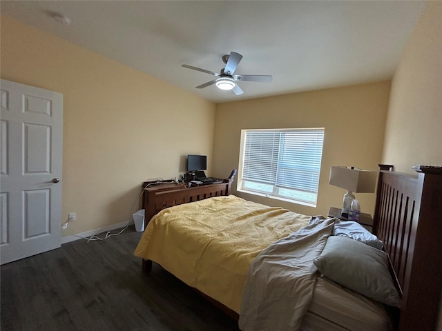 bedroom with dark hardwood / wood-style floors and ceiling fan