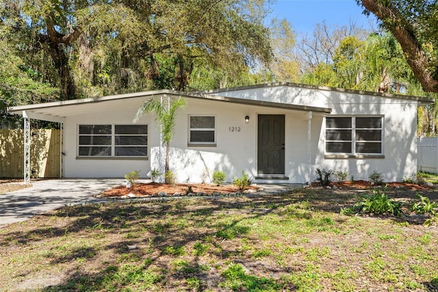 view of front of home featuring driveway and fence