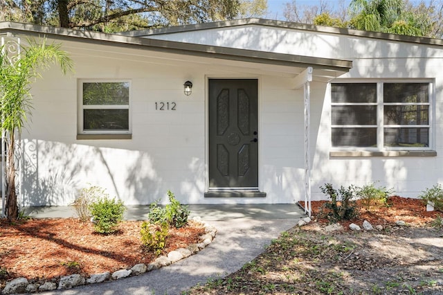 view of exterior entry with concrete block siding