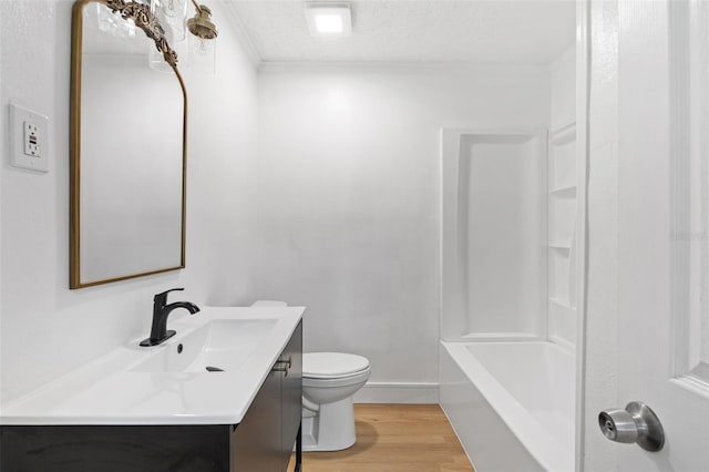 1212 E Crawford St, Tampa, FL 33604 - bathroom featuring vanity, toilet, wood finished floors, a textured ceiling, and baseboards