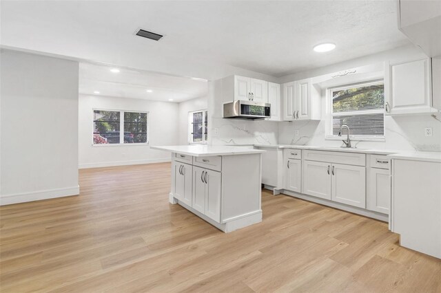 1212 E Crawford St, Tampa, FL 33604 - kitchen with stainless steel microwave, healthy amount of natural light, light wood-style floors, and recessed lighting