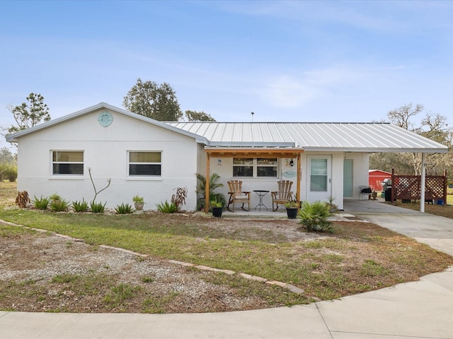 view of front facade with a front lawn and a carport