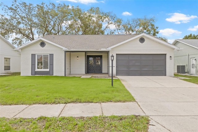 ranch-style home featuring a garage, central AC, brick siding, driveway, and a front lawn