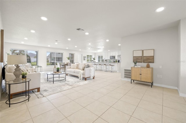 living area featuring recessed lighting, visible vents, and light tile patterned flooring