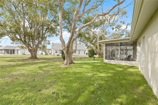 view of yard featuring a residential view and a sunroom