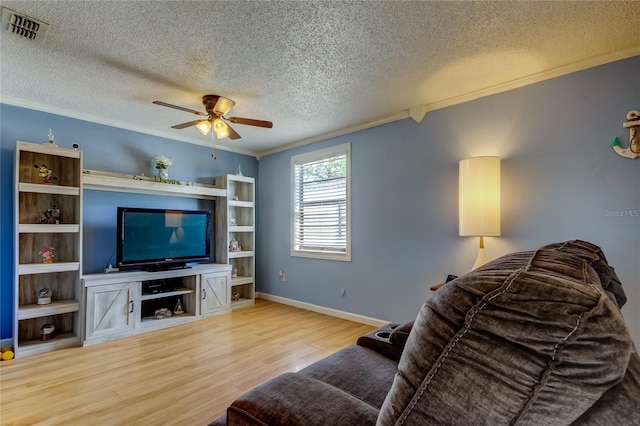 living room featuring light hardwood / wood-style flooring, ceiling fan, and ornamental molding