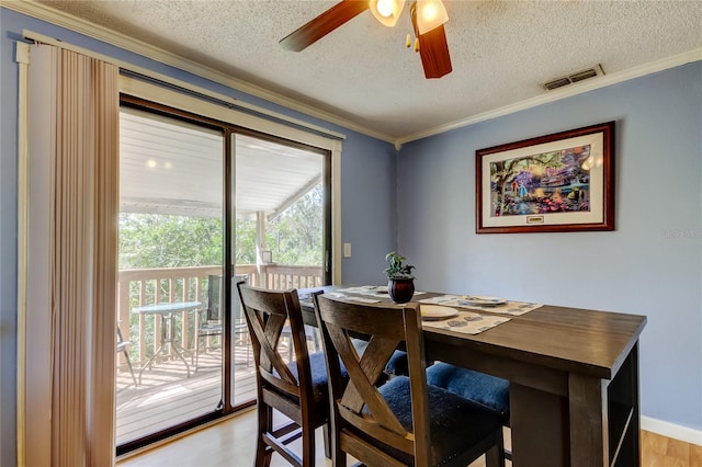 dining area with a textured ceiling, crown molding, ceiling fan, and light hardwood / wood-style flooring