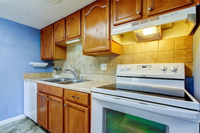 kitchen with sink, white appliances, a textured ceiling, and backsplash