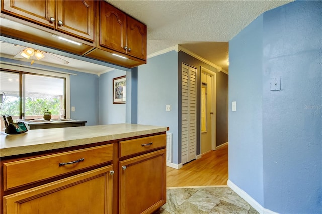 kitchen featuring crown molding and a textured ceiling