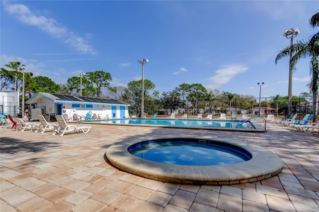 view of pool featuring a patio area and a community hot tub