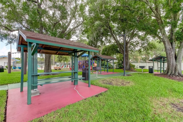 view of home's community with a playground and a lawn