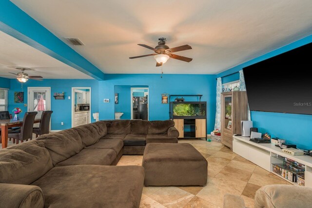 living room featuring visible vents and a ceiling fan