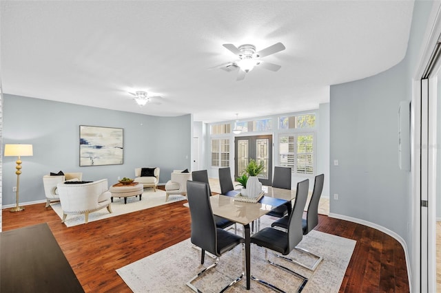 dining room featuring wood finished floors, baseboards, and ceiling fan