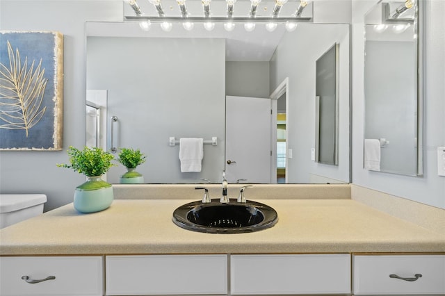 bathroom featuring toilet and vanity