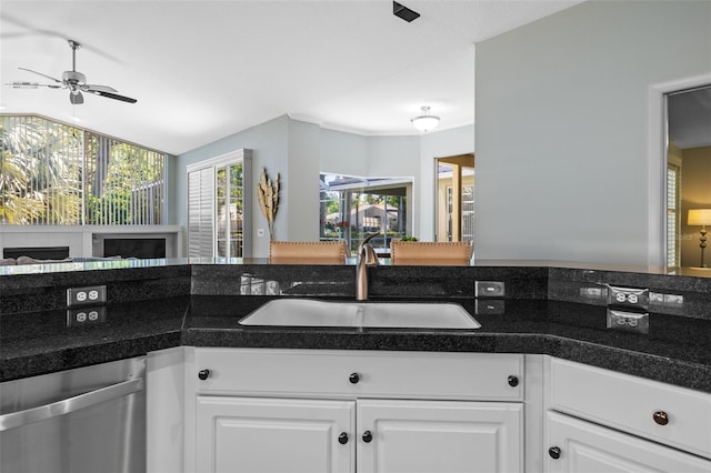 kitchen with a ceiling fan, a sink, white cabinets, stainless steel dishwasher, and open floor plan