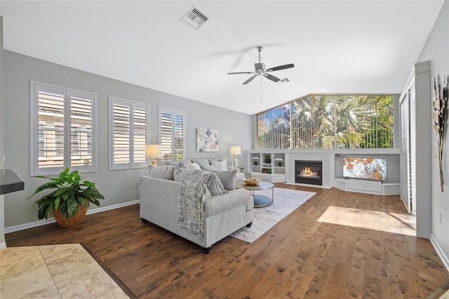 living room featuring visible vents, hardwood / wood-style floors, ceiling fan, and vaulted ceiling