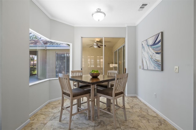 dining area featuring visible vents, a ceiling fan, crown molding, and baseboards