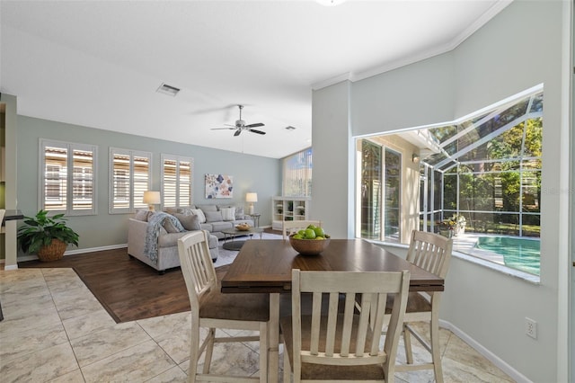 dining room with baseboards, visible vents, a sunroom, and ceiling fan