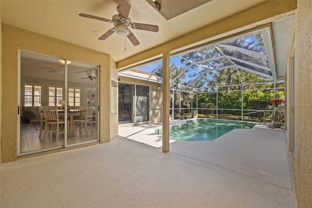 pool featuring glass enclosure, a patio, and ceiling fan