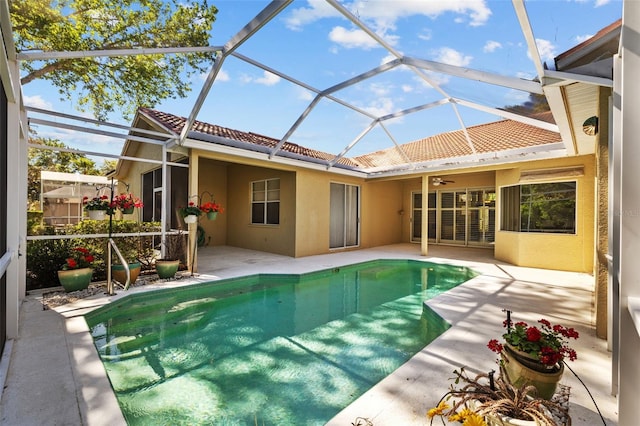 outdoor pool featuring a lanai, a patio, and ceiling fan