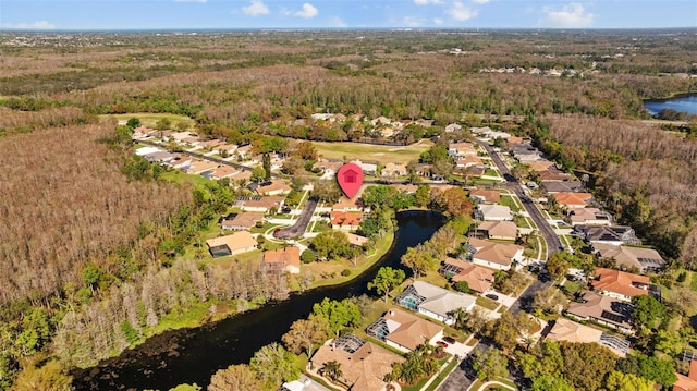 bird's eye view featuring a view of trees, a water view, and a residential view