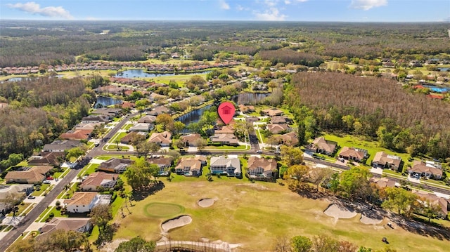 aerial view with a residential view, golf course view, a forest view, and a water view