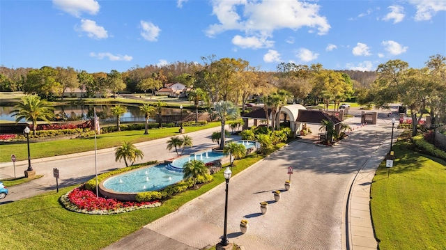 view of community with a yard and a water view