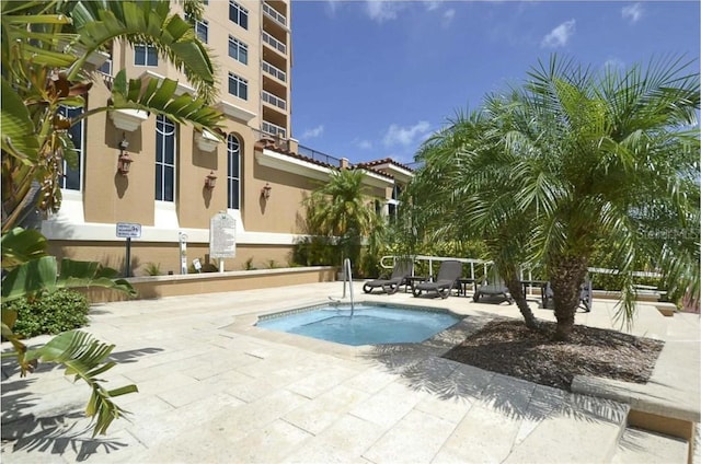 view of pool featuring a patio area and a hot tub