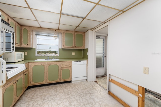 kitchen with white appliances, sink, a paneled ceiling, and green cabinetry