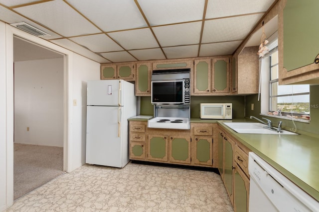 kitchen with white appliances, sink, and a paneled ceiling