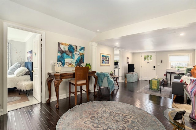 interior space with vaulted ceiling and dark hardwood / wood-style floors