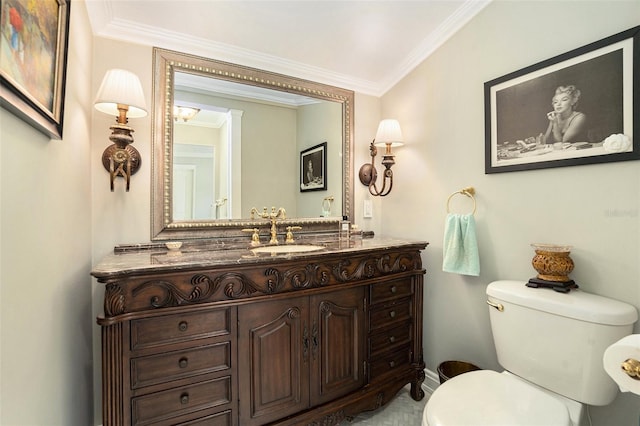 bathroom with ornamental molding, vanity, and toilet