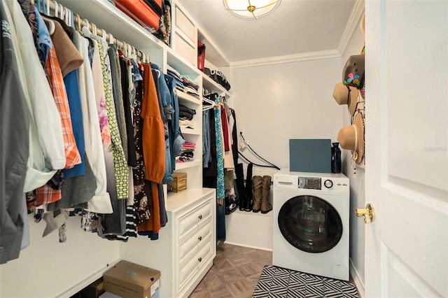 interior space featuring ornamental molding, dark parquet flooring, and washer / dryer