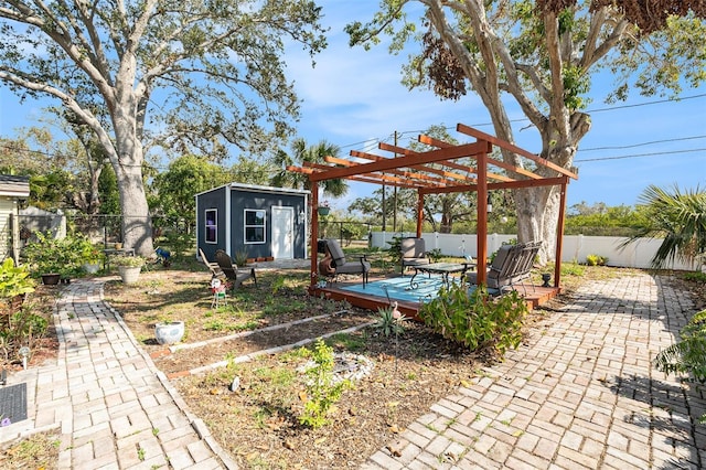 view of patio with a pergola, a wooden deck, and a storage shed