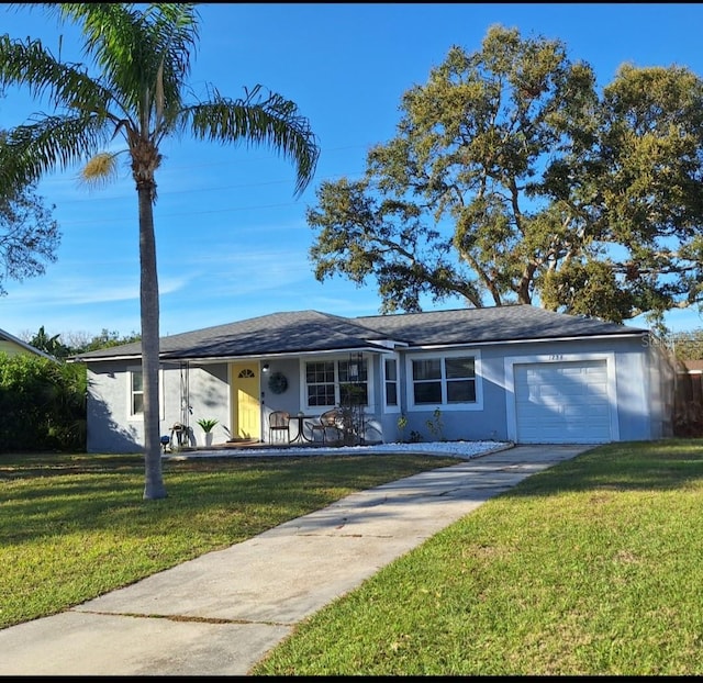 ranch-style home with an attached garage, driveway, a front lawn, and stucco siding