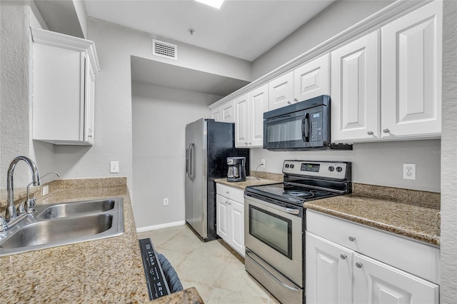 kitchen featuring a sink, stainless steel appliances, visible vents, and white cabinetry